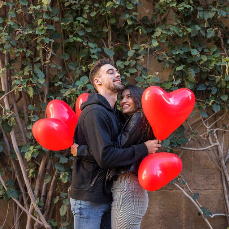 young-happy-man-hugging-smiling-woman-holding-balloons-form-hearts_23-2148013713.jpg